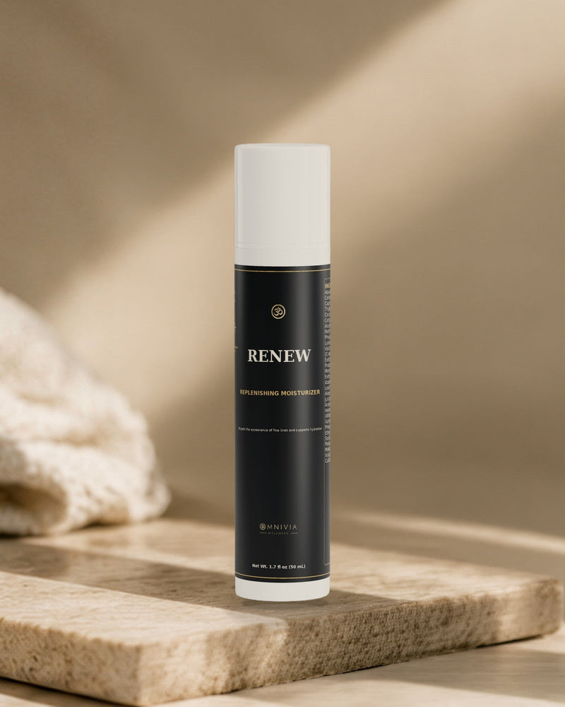 Renew Replenishing Moisturizer airless pump standing on a travertine slab in warm directional light
