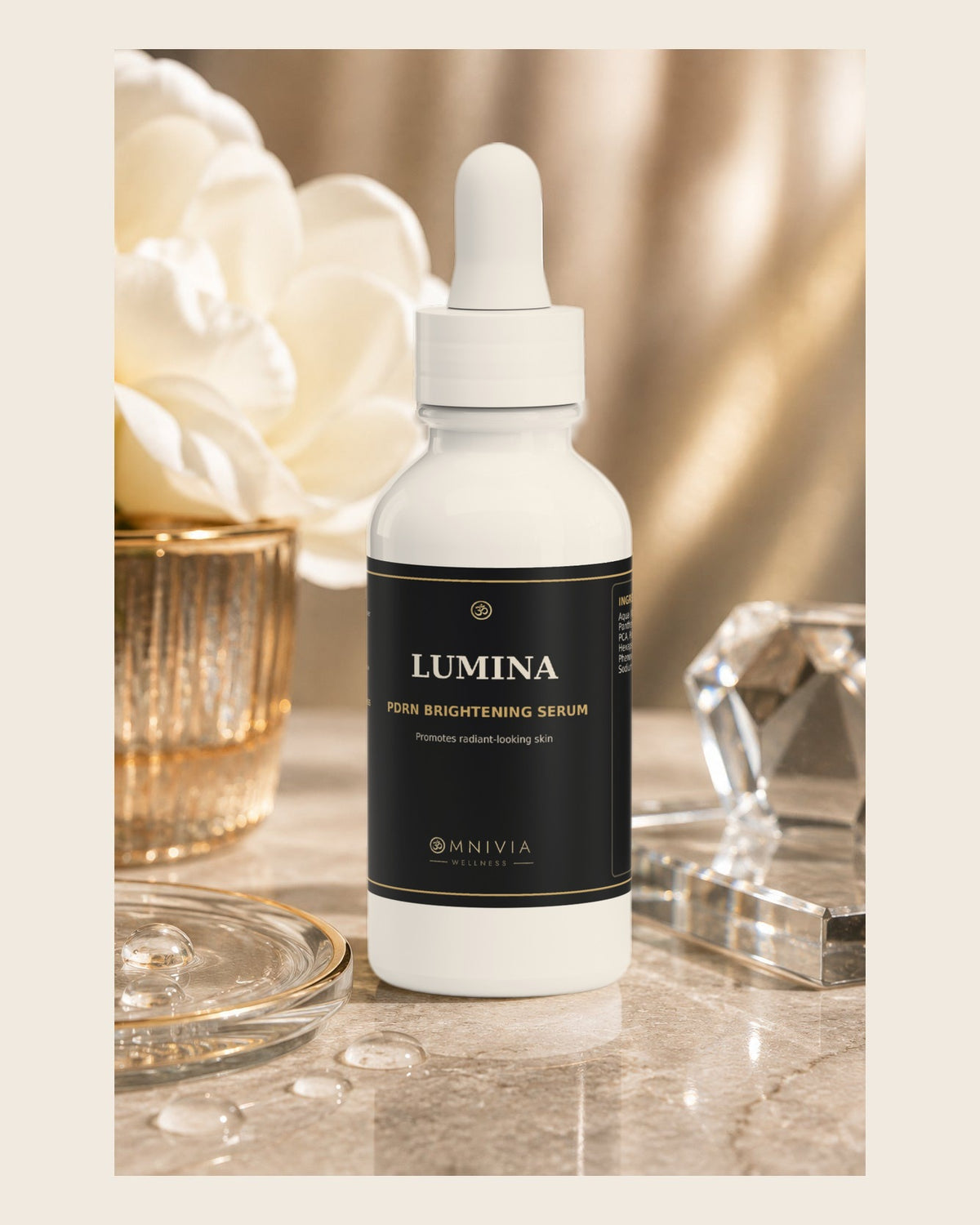 Lumina PDRN Brightening Serum dropper bottle beside white flowers and crystal on marble
