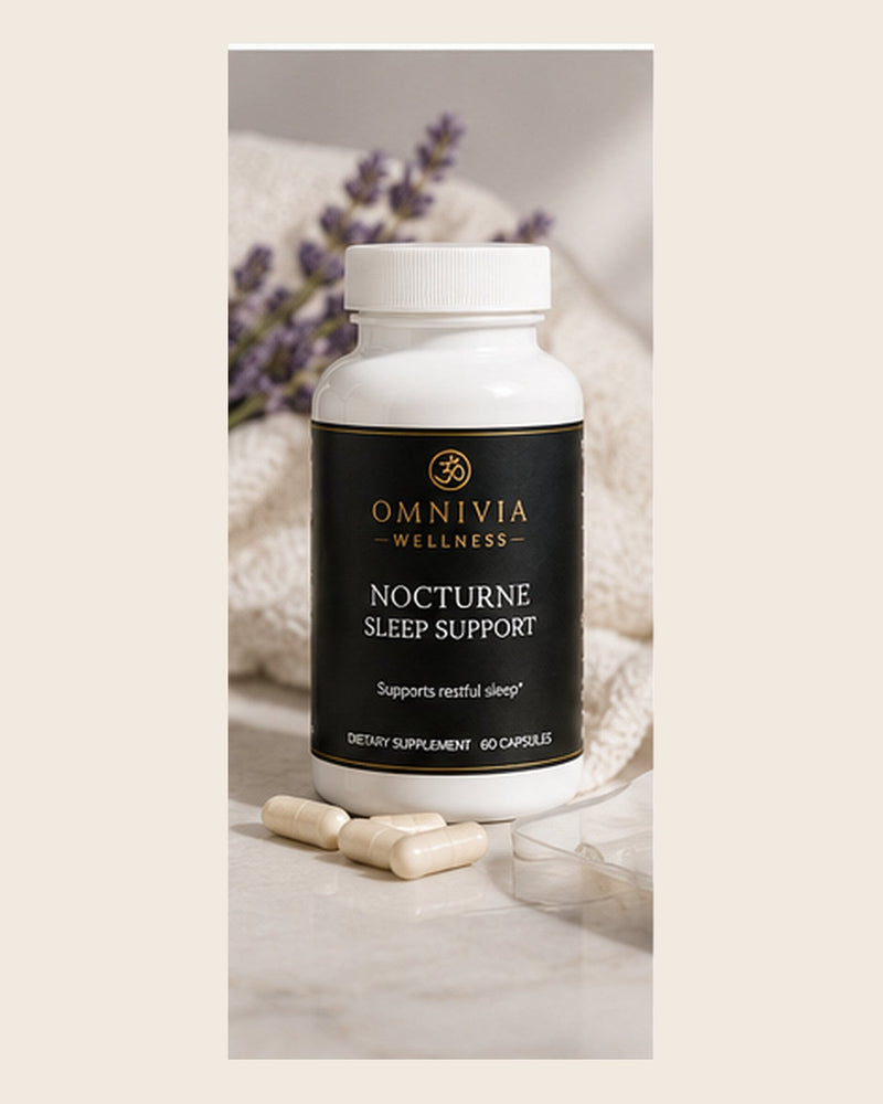 Nocturne Sleep Support capsule bottle with a black and gold Omnivia Wellness label beside lavender sprigs and capsules