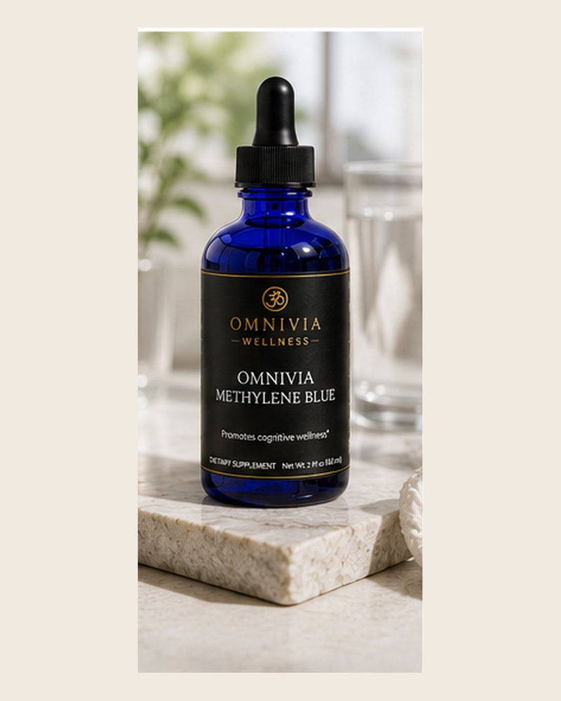 Omnivia Methylene Blue in a cobalt blue dropper bottle with a black and gold label on a stone plinth