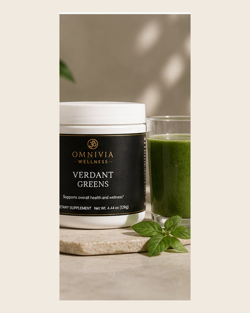 Verdant Greens tub with a black and gold Omnivia Wellness label beside a glass of green juice and basil leaves
